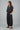 Woman wearing black linen pants and black linen top